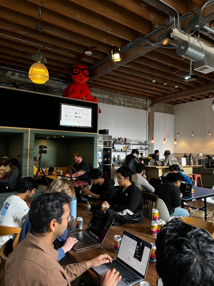 Hackers building at tables in the event space