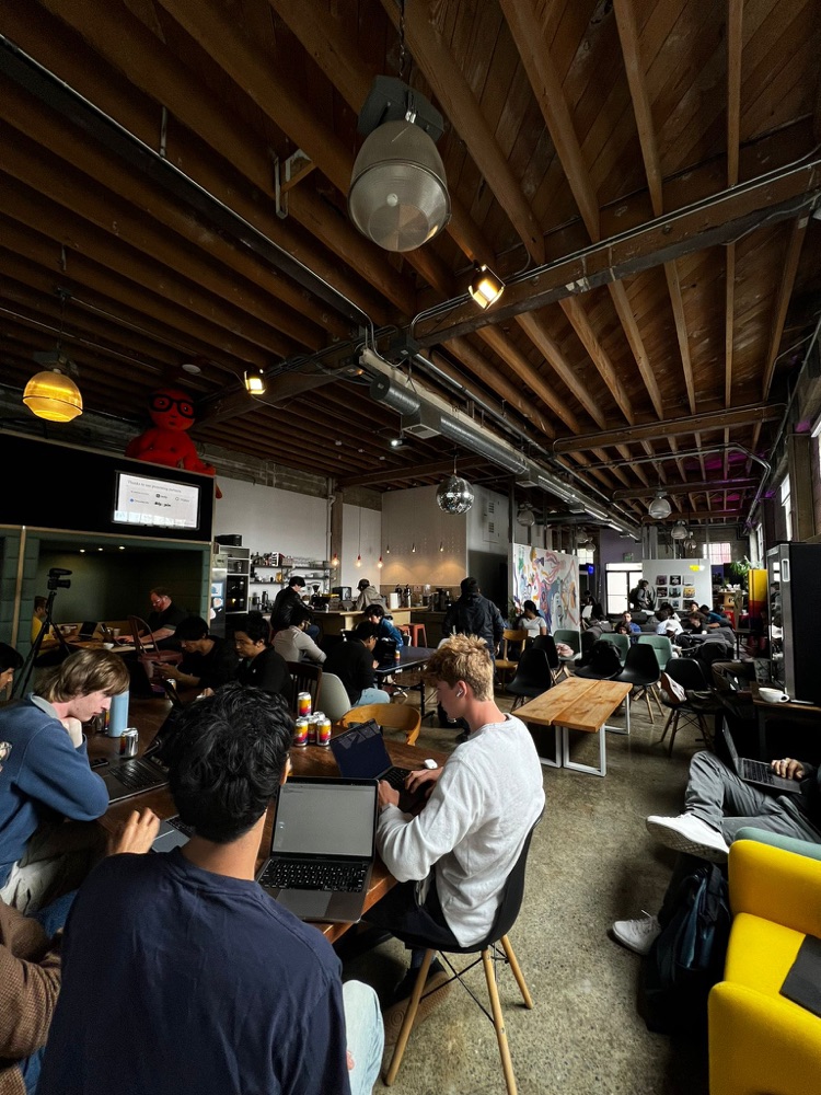 Wide view of the hackathon venue buzzing with teams at work
